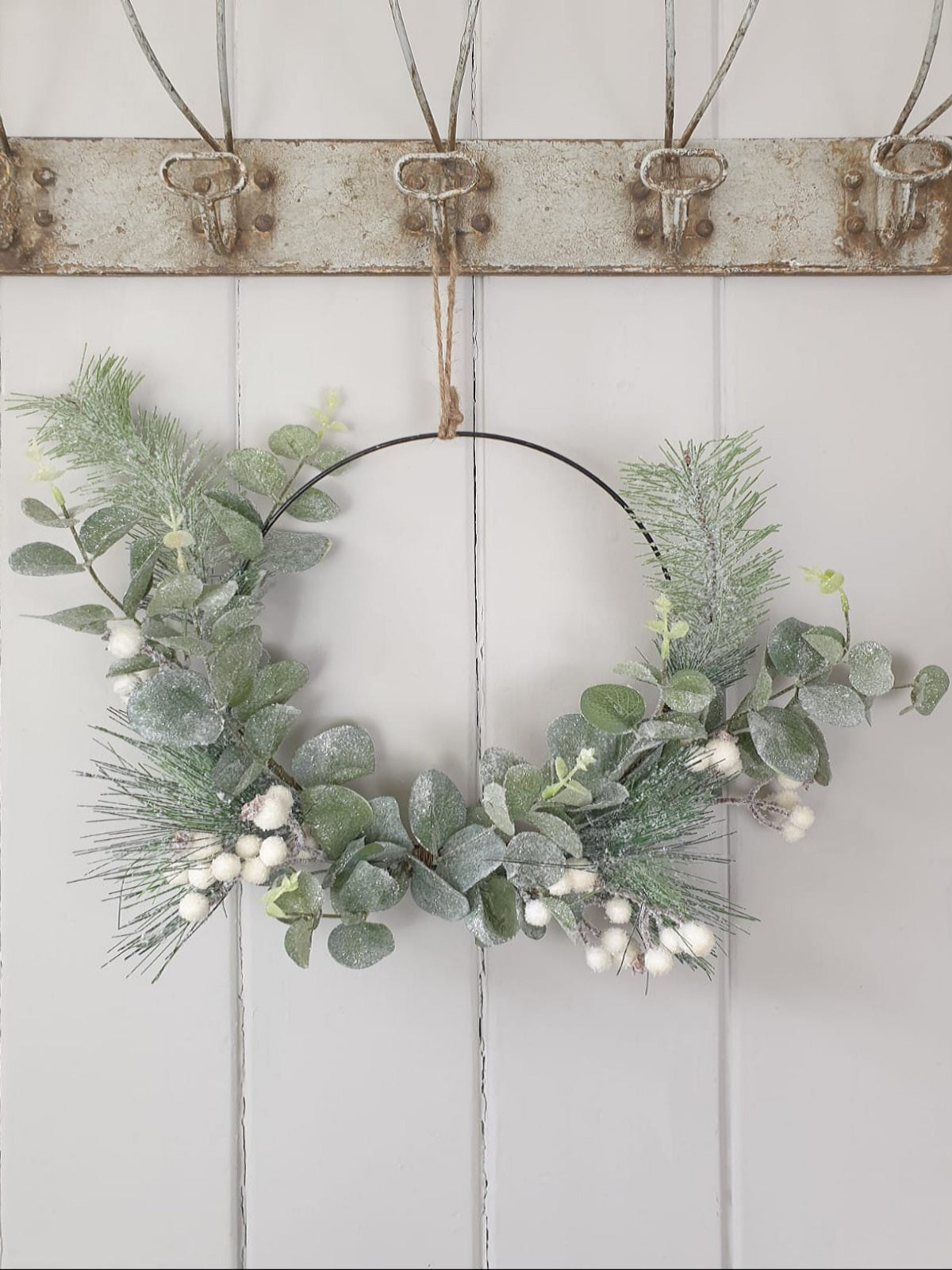 Green leaf and white berry on metal wreath