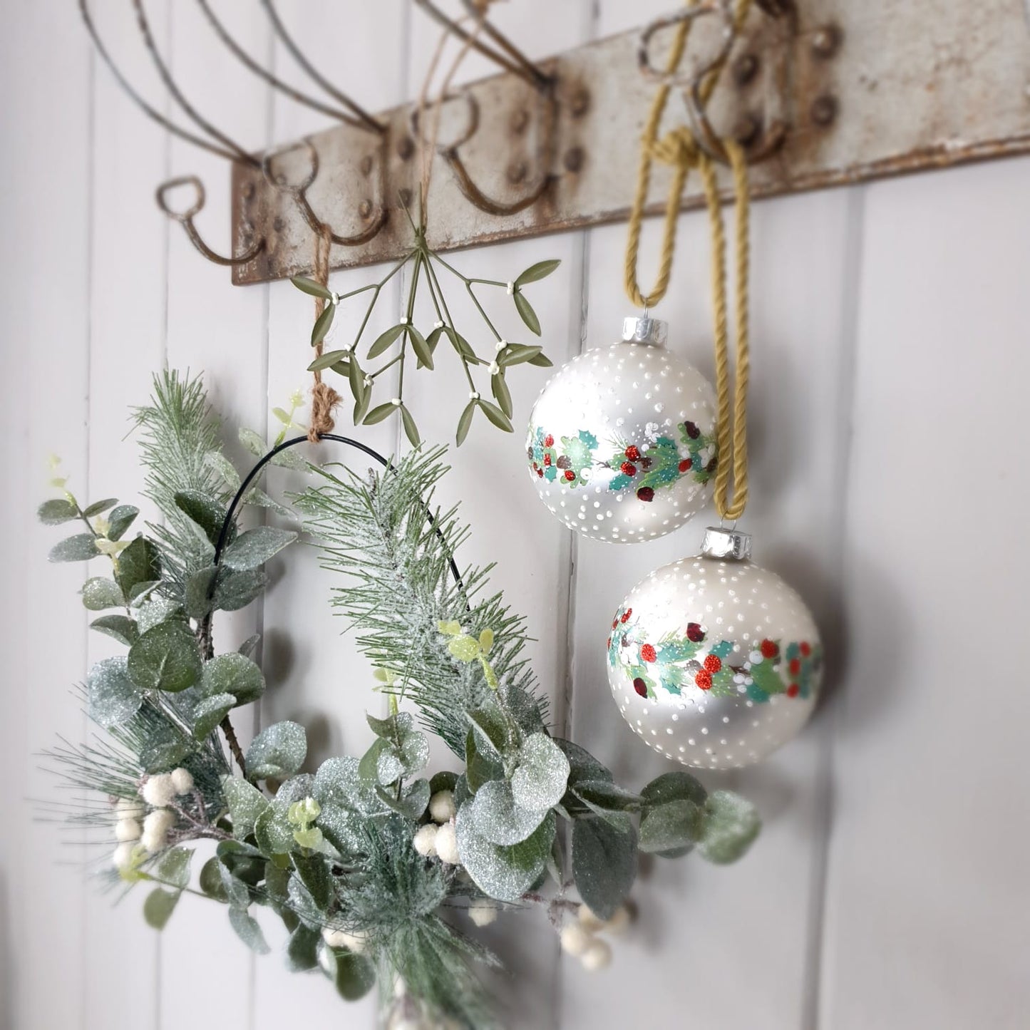 Green leaf and white berry on metal wreath
