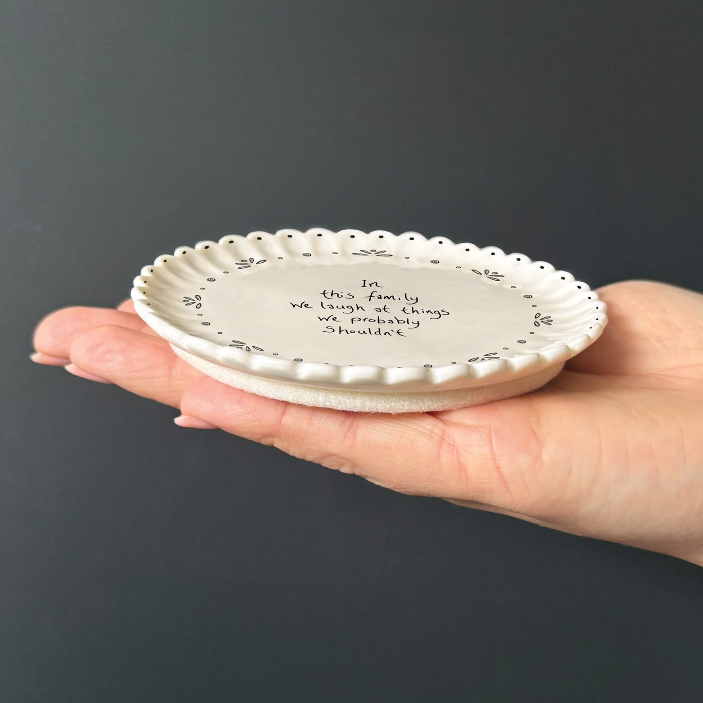 Porcelain scalloped round coaster - In this family we laugh at things we probably shouldn’t