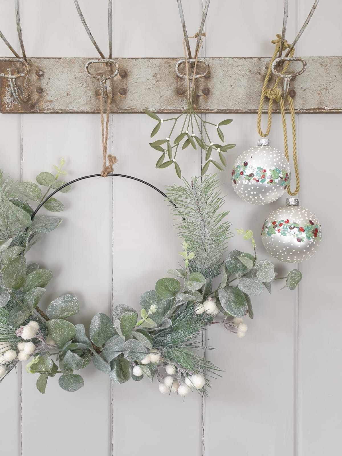 Green leaf and white berry on metal wreath