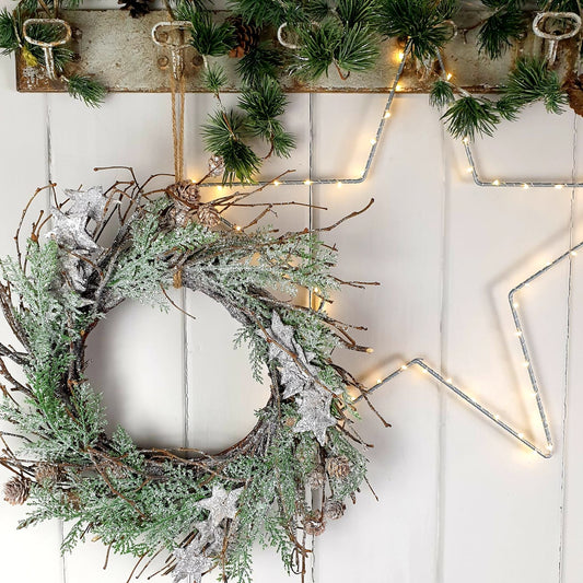 Wreath with silver stars and pine cones